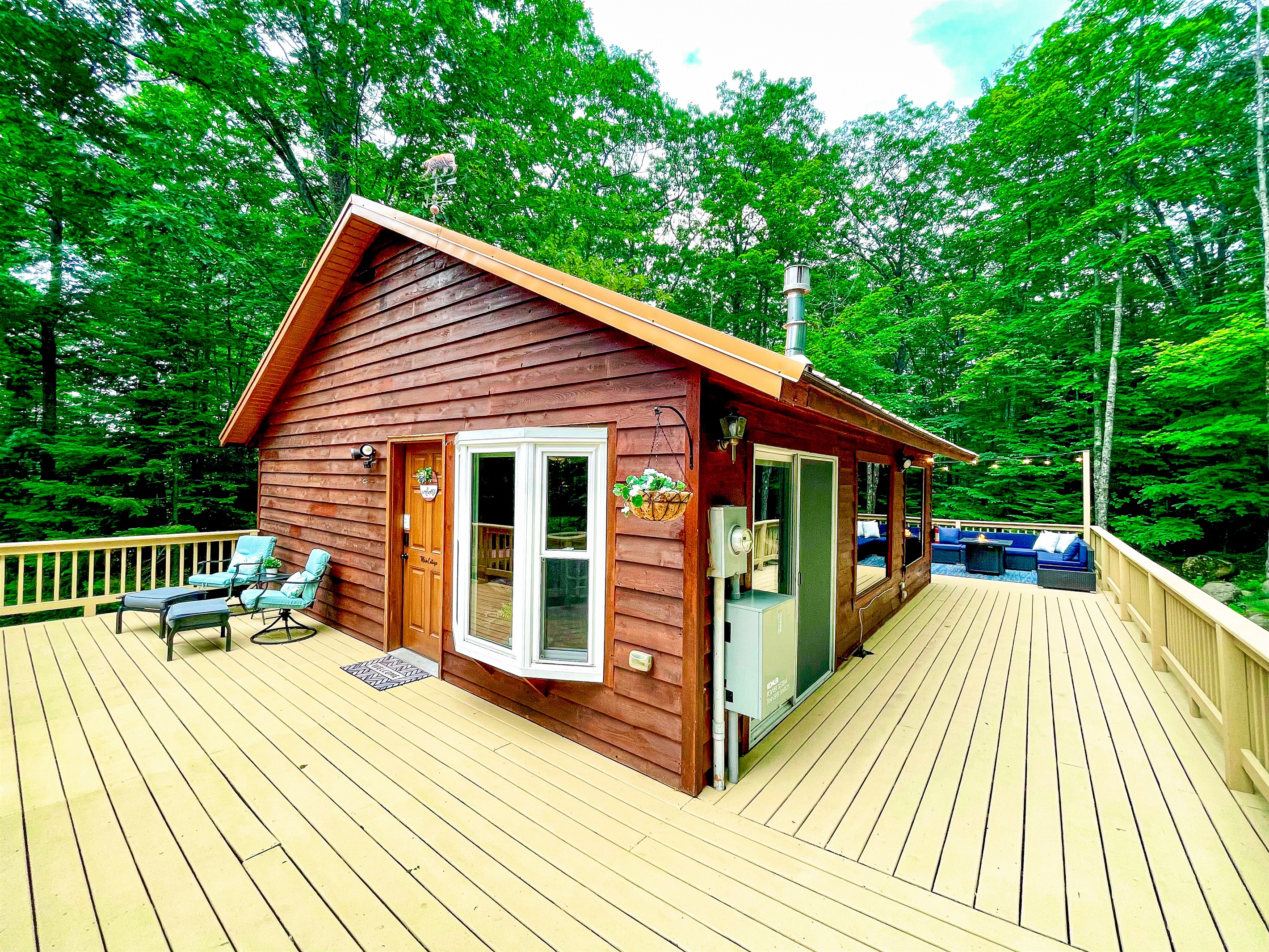 Front corner of Main Cottage wrap around deck location of grill, gives views of both front and some of back deck. 