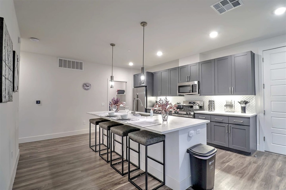 - Enjoy a modern kitchen with stylish pendant lighting and breakfast island   - Fully stocked with cooking essentials, perfect for shared meals and gatherings   - Sleek finishes and comfortable seating make dining easy and enjoyable