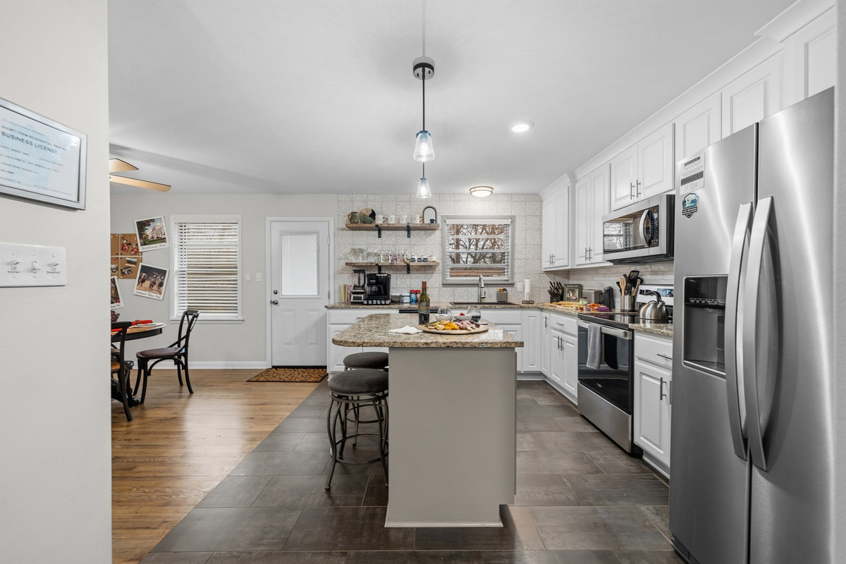 Cook for the whole crew — a granite island with bar seating, full-size fridge, and room for three sets of hands at once.