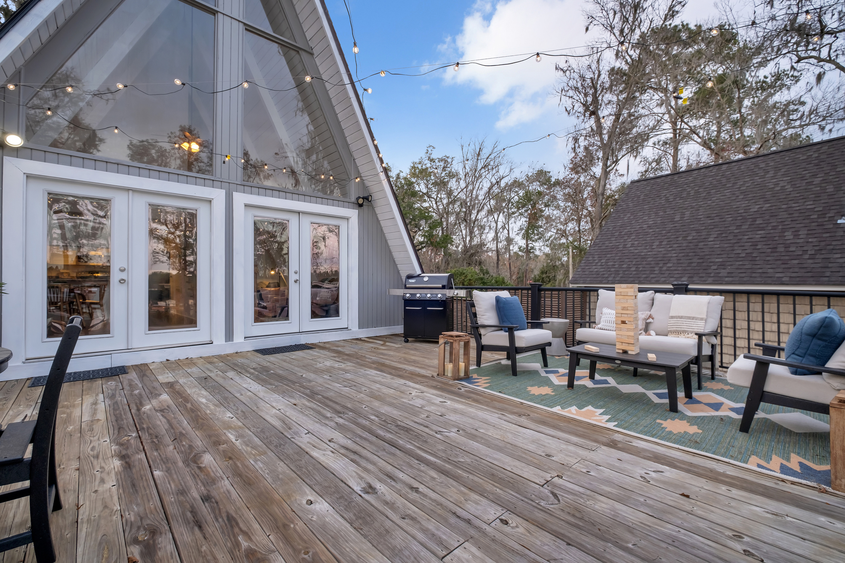 Deck off the living room, propane grill, lounge seating, giant Jenga
