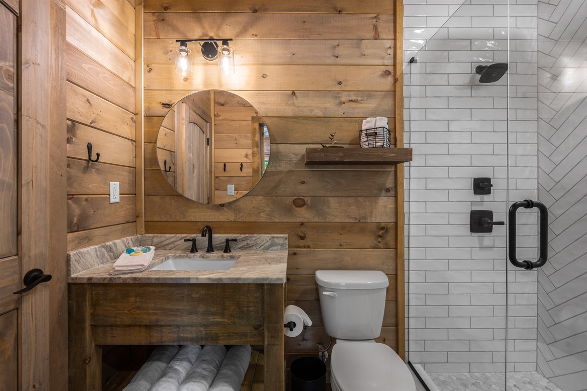 The lower level suite bathroom has a shower and closet. 