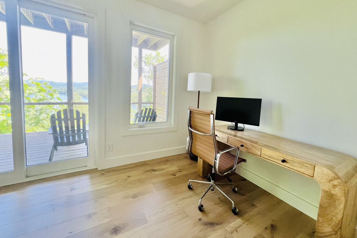 Work with a view.
Need to check in with the office? A dedicated workspace in the rec room offers a comfortable desk setup and lake views that make remote work a little easier.