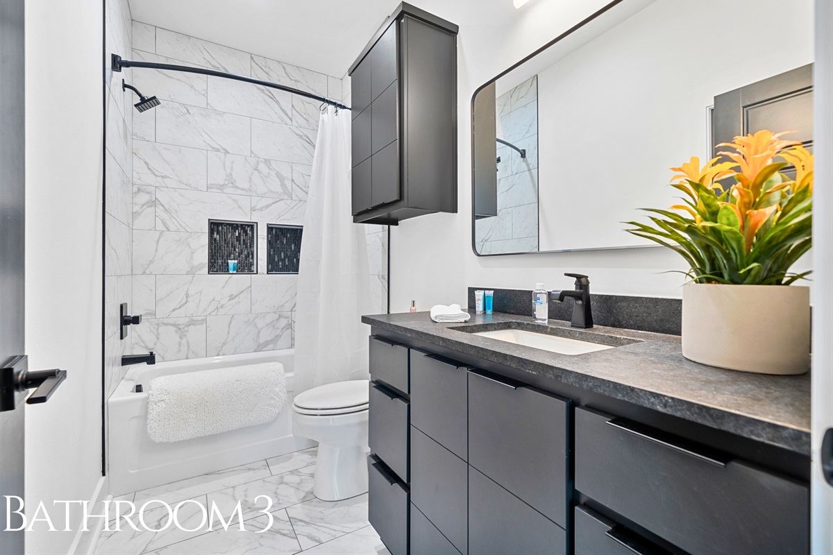 This bathroom strikes the perfect balance of sleek design and functionality, with its clean finishes, a comfortable shower-tub combo, and a fresh, inviting vibe.