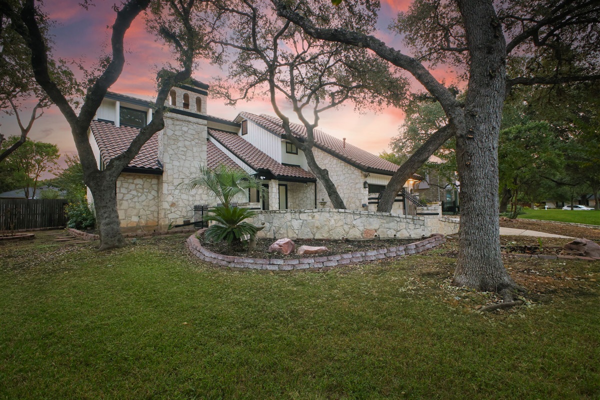 Majestic trees create a serene, inviting first impression.