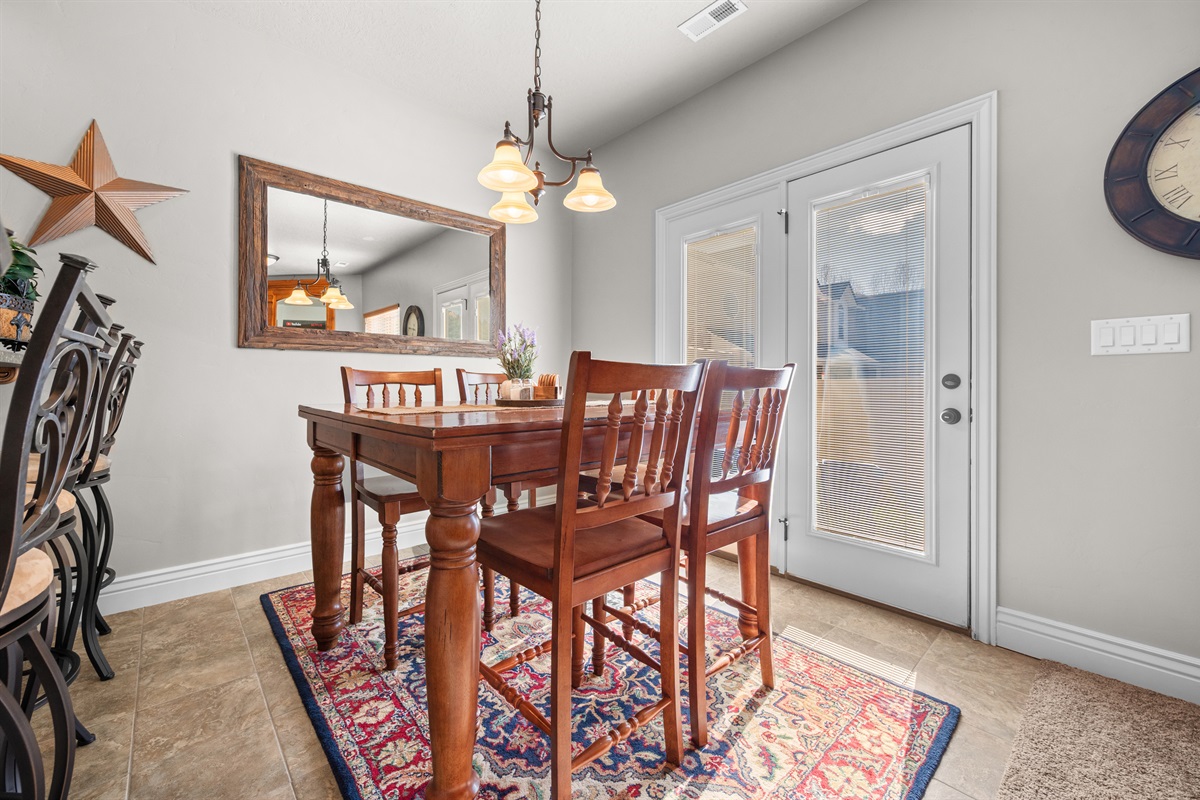 Bright dining space for five guests with easy access to the patio for indoor-outdoor living.