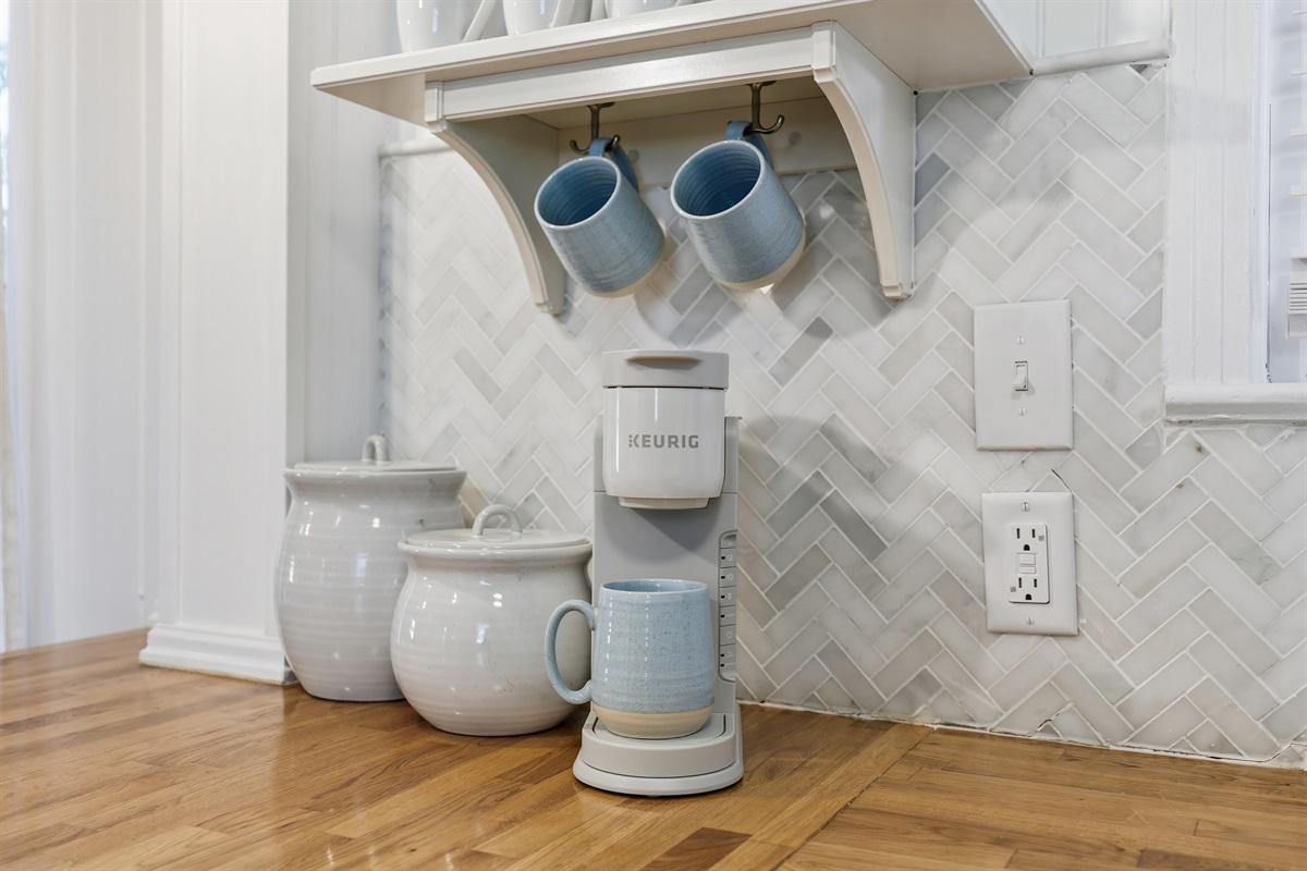 Kitchen coffee bar setup &mdash; Keurig + coastal mugs + provided coffee to start your mornings right