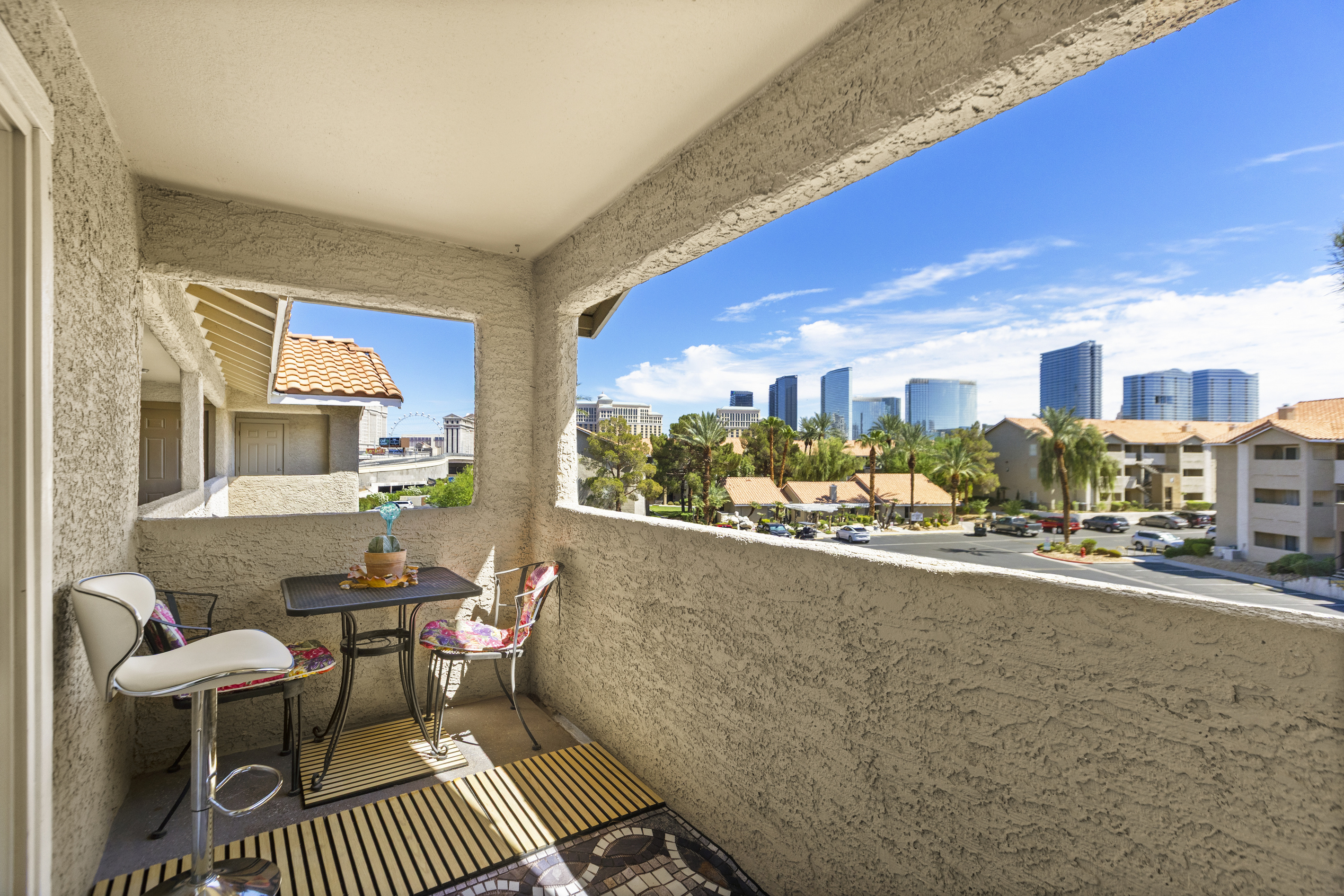 Private balcony with outdoor seating overlooking the Las Vegas Strip