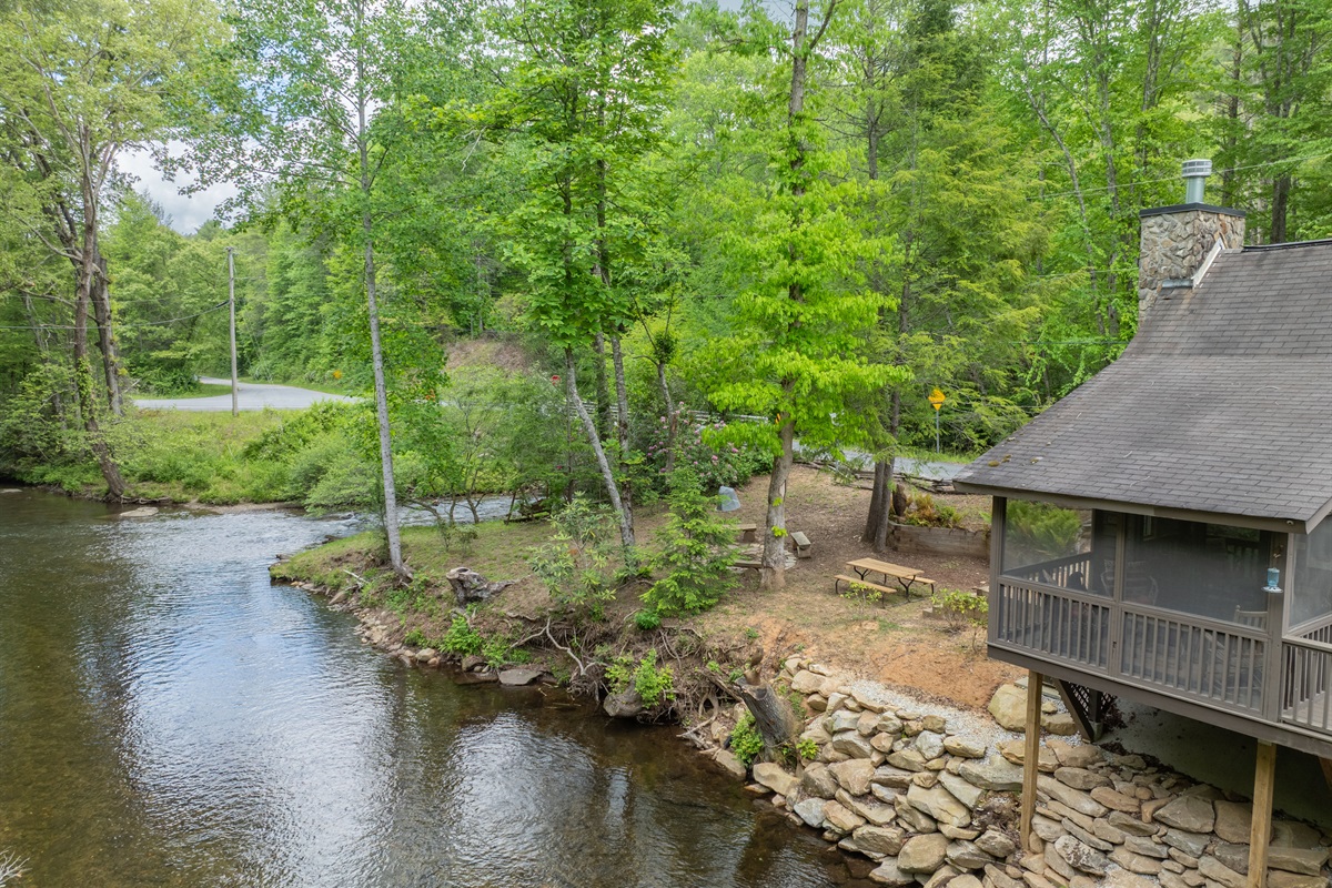 With the creek running alongside the property, guests can enjoy the sights and sounds of the water from multiple outdoor spaces around the cabin.