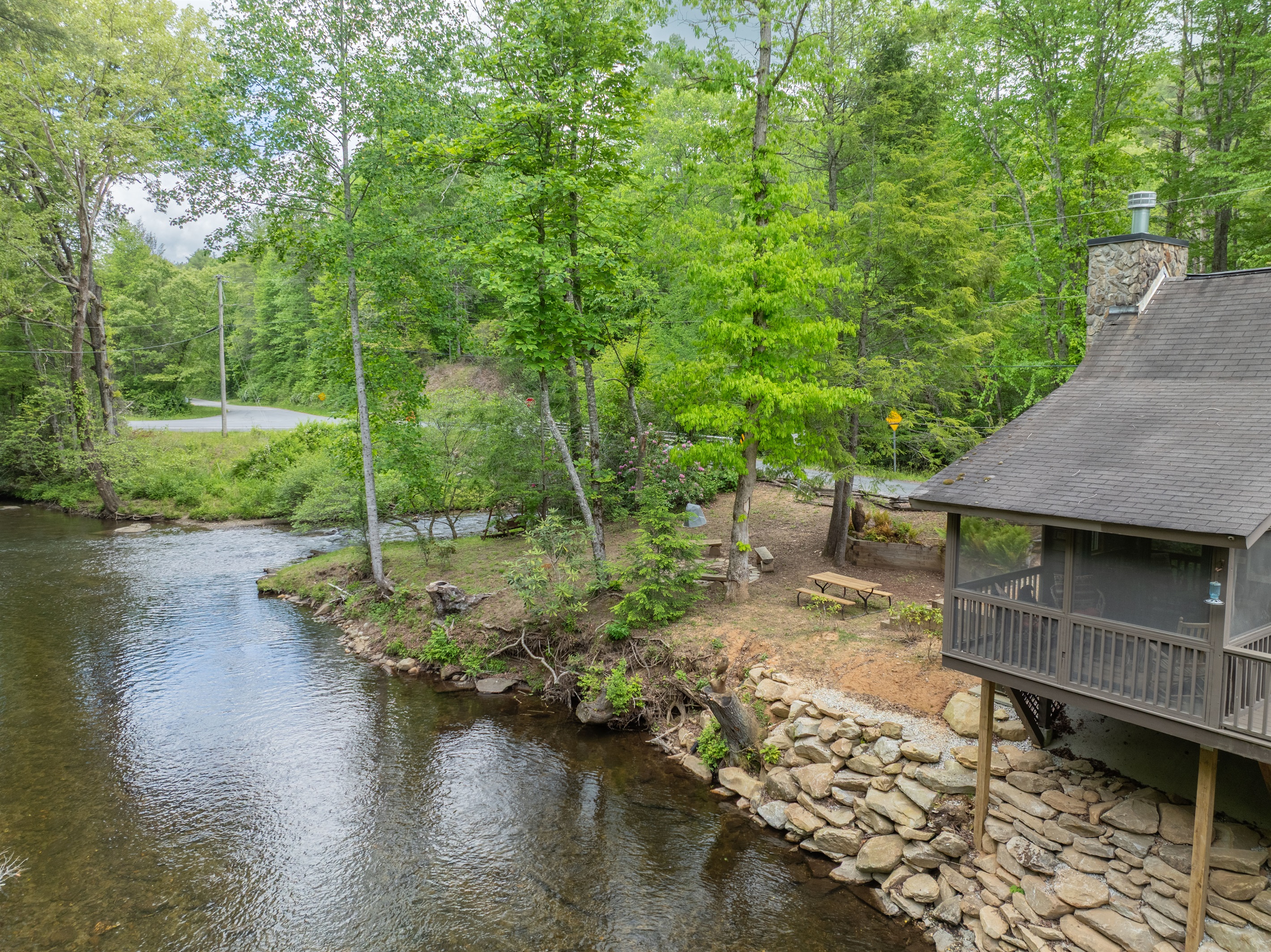 With the creek running alongside the property, guests can enjoy the sights and sounds of the water from multiple outdoor spaces around the cabin.