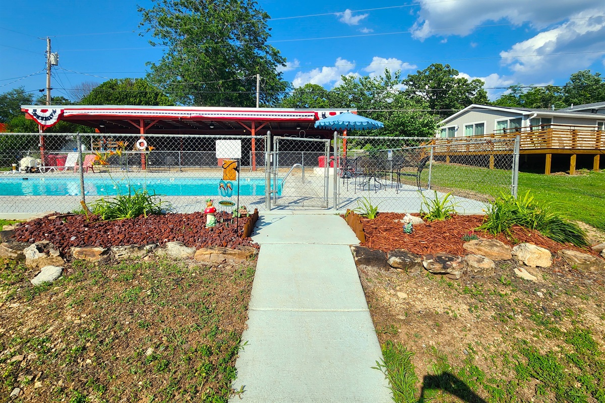 The entry into the pool area welcomes you with flowers and gnomes