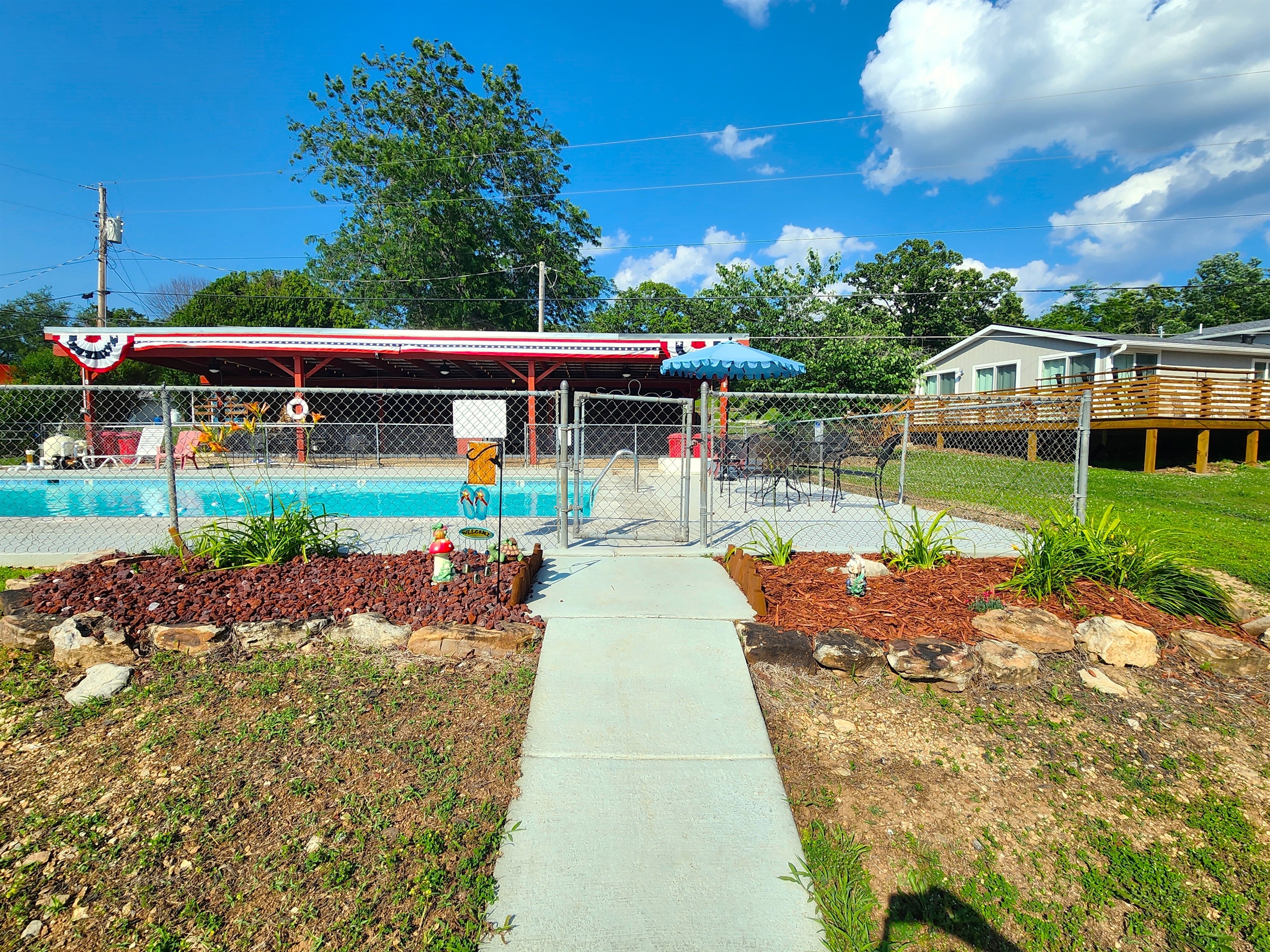 The entry into the pool area welcomes you with flowers and gnomes