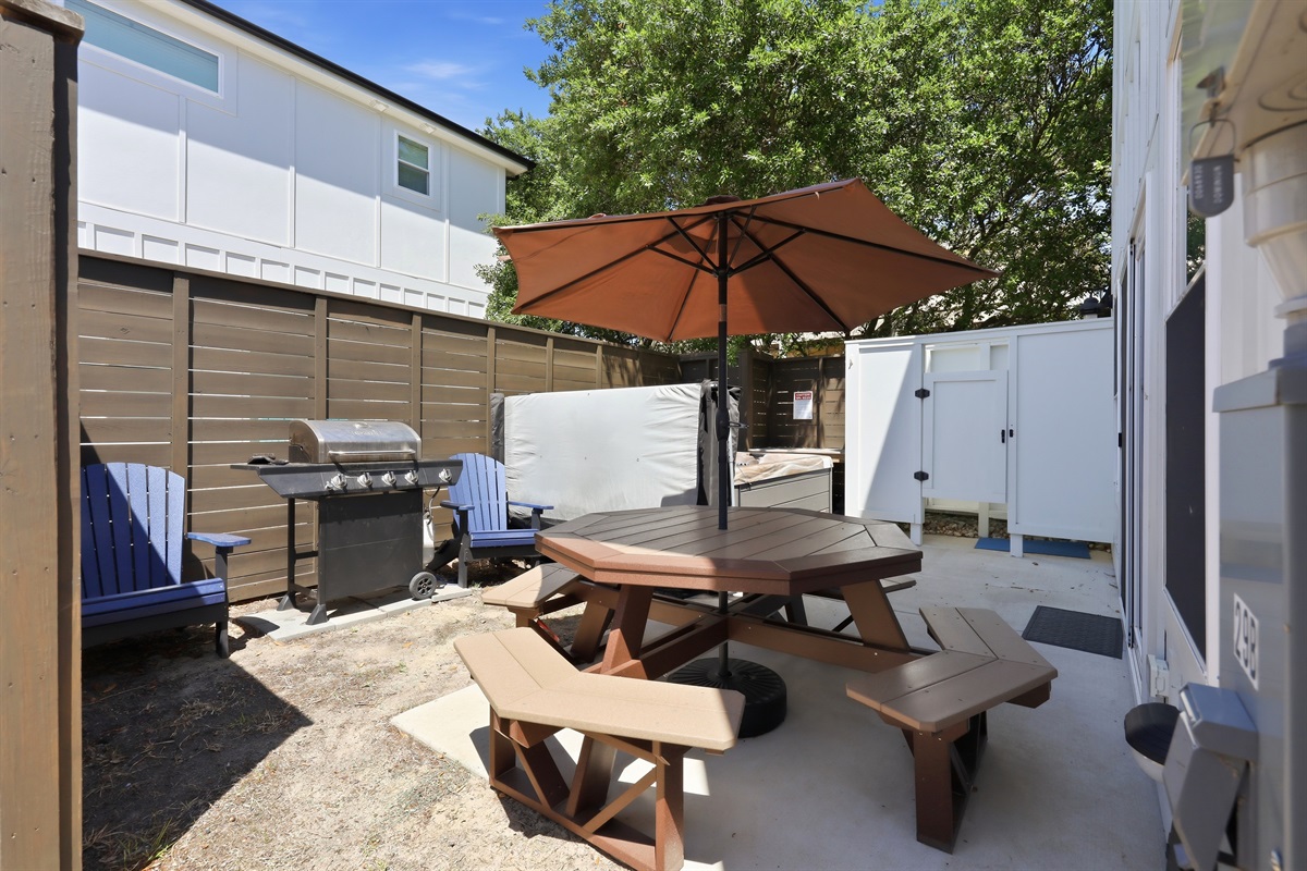Outdoor dining area with grill and seating