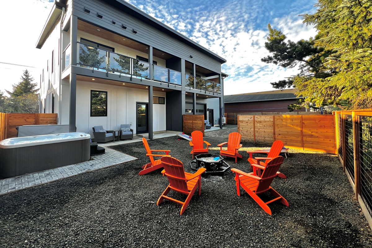 8a Villa B's private outdoor entertainment area — hot tub, fire pit, seating for the whole crew.