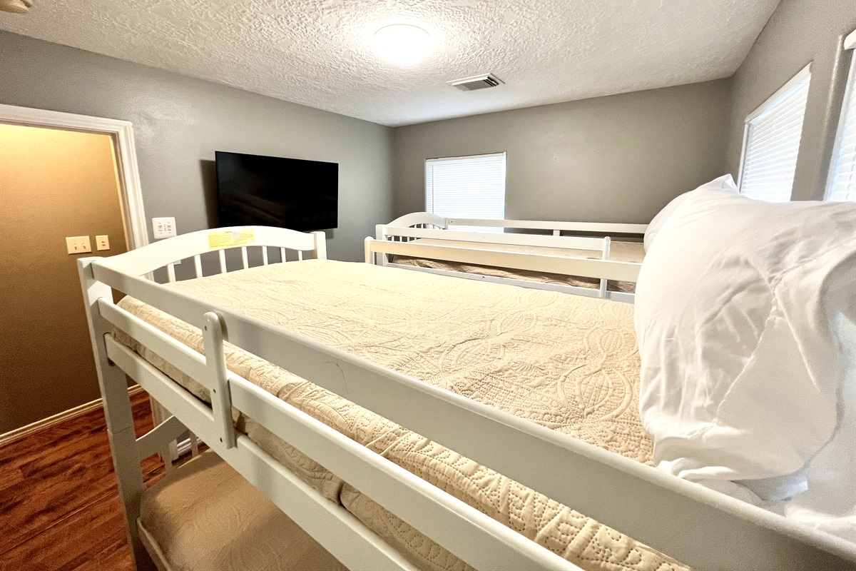 Bunk room with twin beds and smart tv