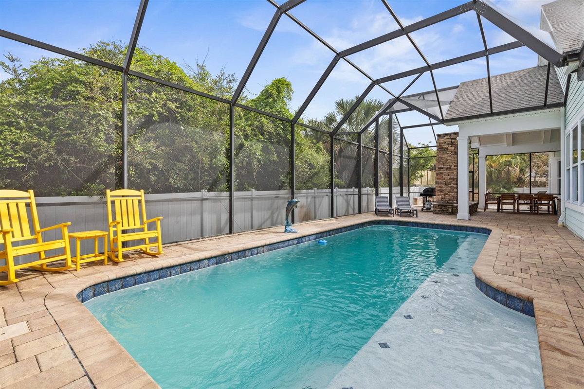 Claim your favorite yellow rocker, slip into the pool after the beach, grill dinner under the lanai, and end the night by the fireplace—this private screened retreat turns ordinary afternoons into the kind of vacation memories you wish lasted longer.