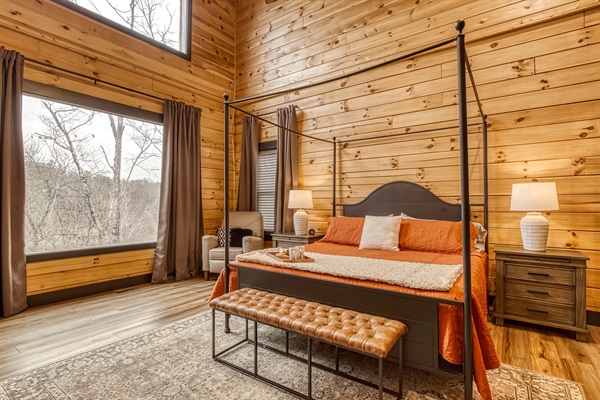 Wake up to soft morning light and peaceful forest views from this cozy, sunlit bedroom