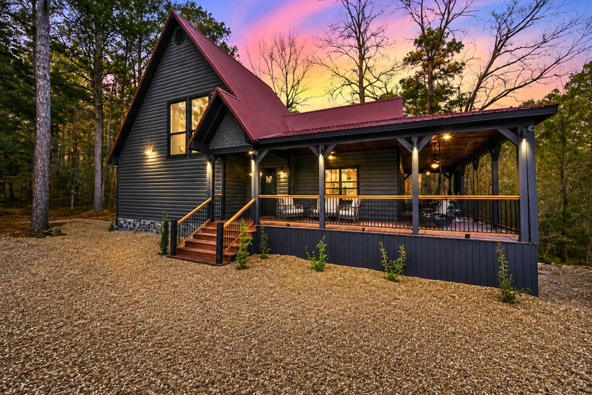 From this exterior angle, the inviting porch spaces and classic A-frame design stand out beautifully against the natural surroundings.