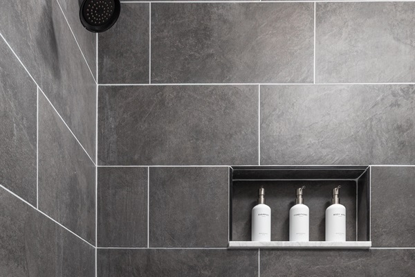 Bathroom with full tub—shampoo, conditioner, and body wash provided for your comfort.