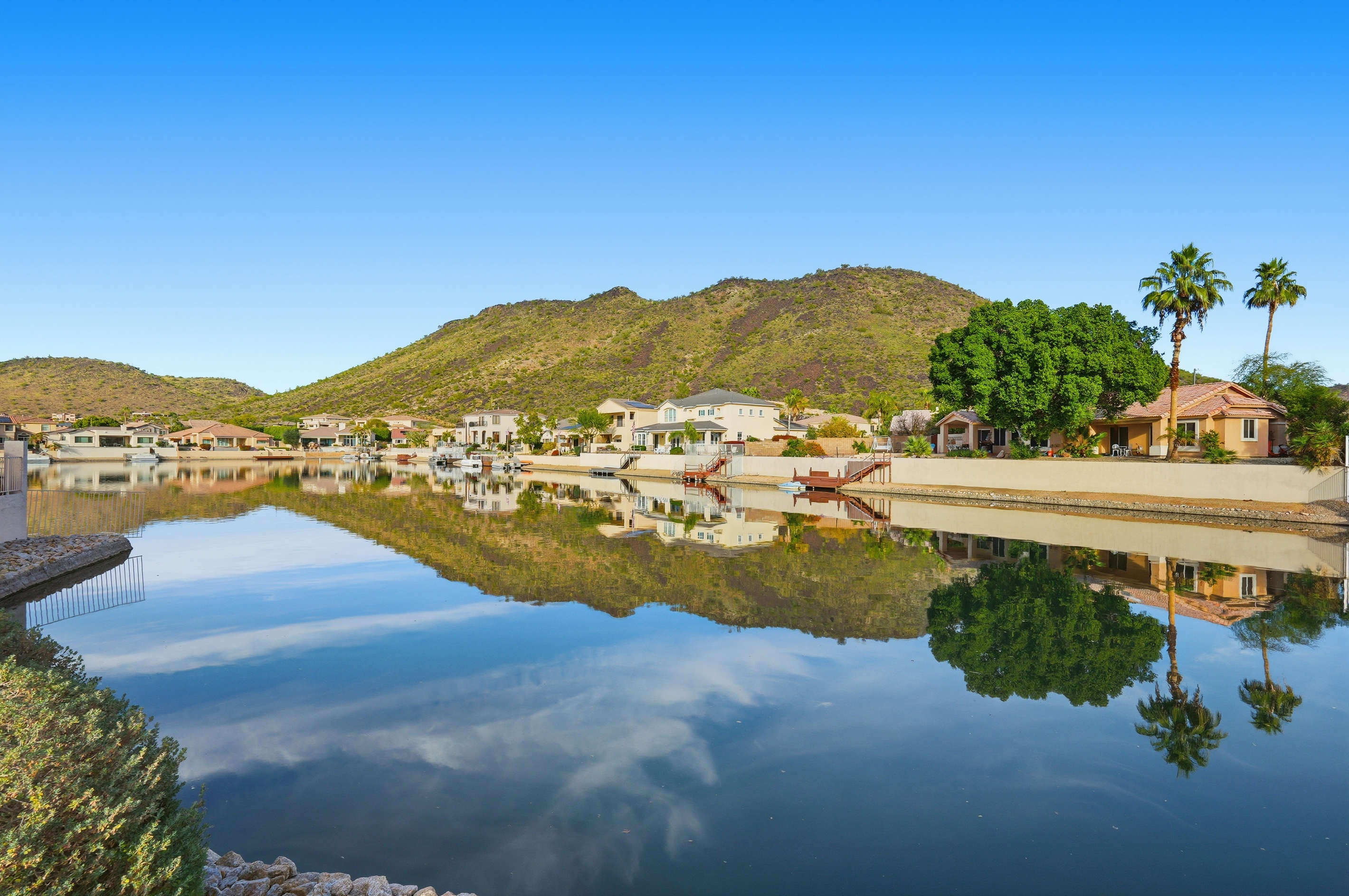 Arrowhead Lakes views with calm water, mountain backdrop, and scenic neighborhood surroundings nearby.