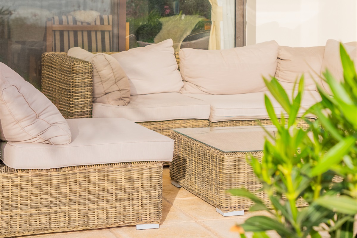 Large sectional sofa on the covered patio inviting guests to relax and enjoy the garden and the views.