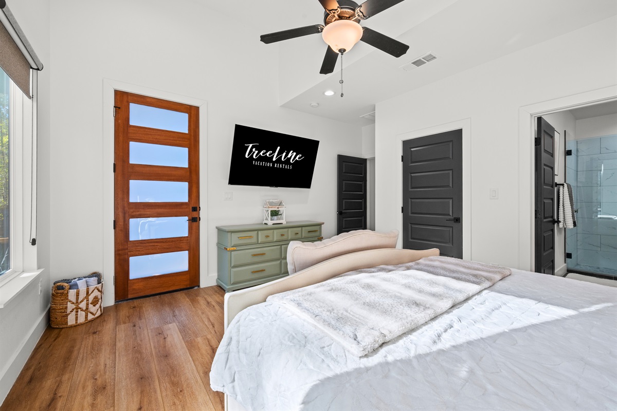 Another view of the primary bedroom highlights the spacious layout and thoughtfully chosen design details.