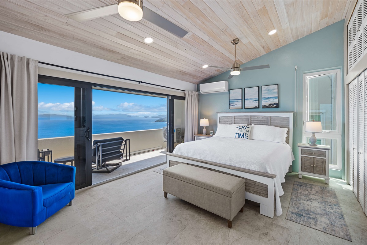 Primary bedroom with large balcony, ceiling fan, smart TV and ensuite bathroom