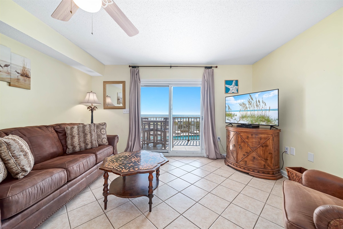 Enjoy your morning coffee with a breathtaking ocean view from the comfort of this living room, featuring a sleeper sofa for extra guests.