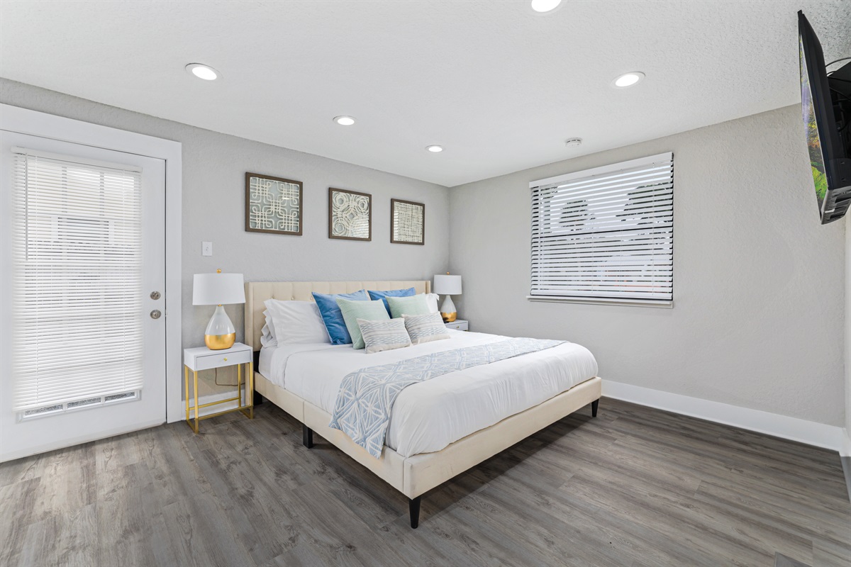 Primary bedroom with king sized bed and smart TV