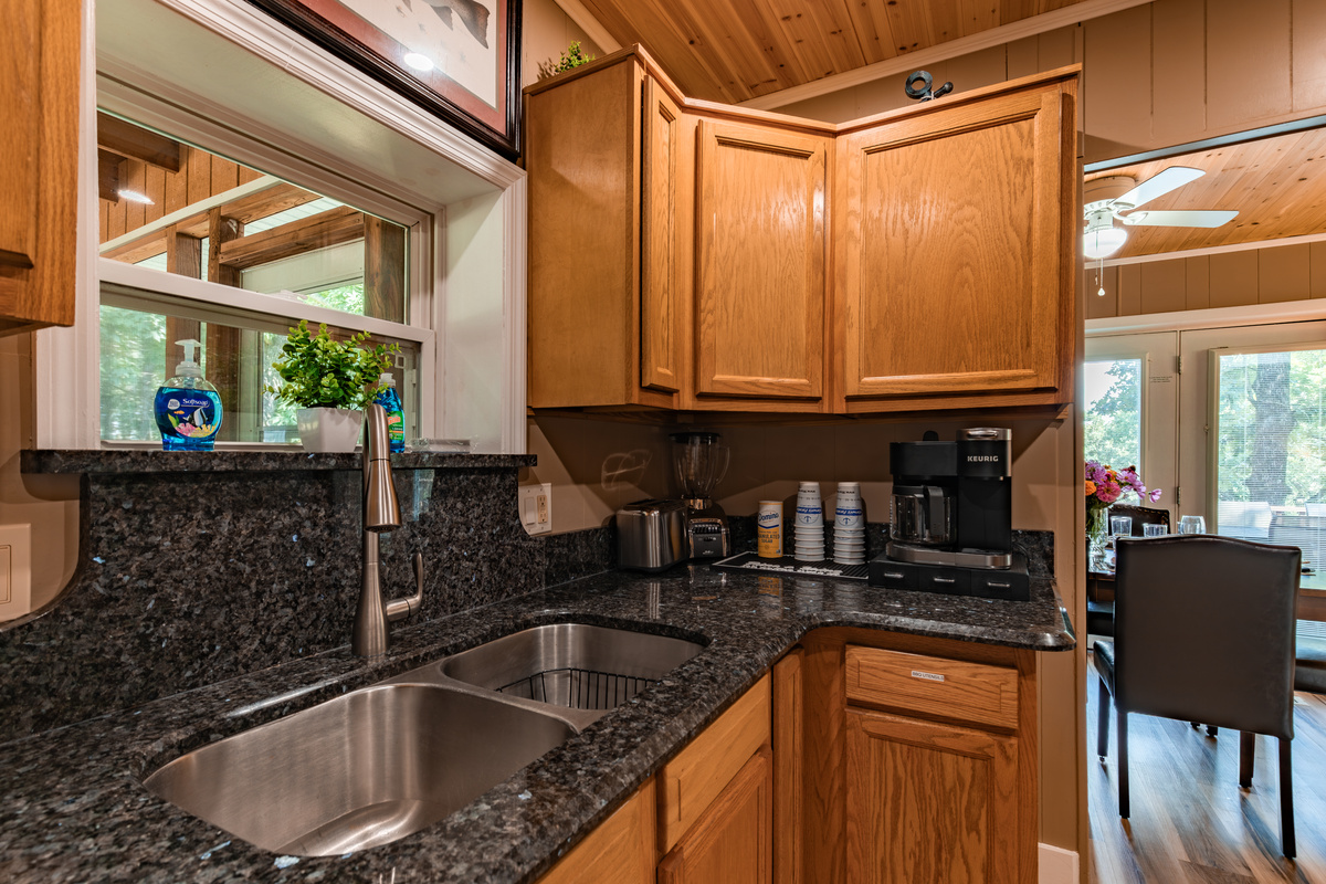 Granite countertops, a roomy sink, and plenty of prep space make cooking and cleanup simple during family stays.