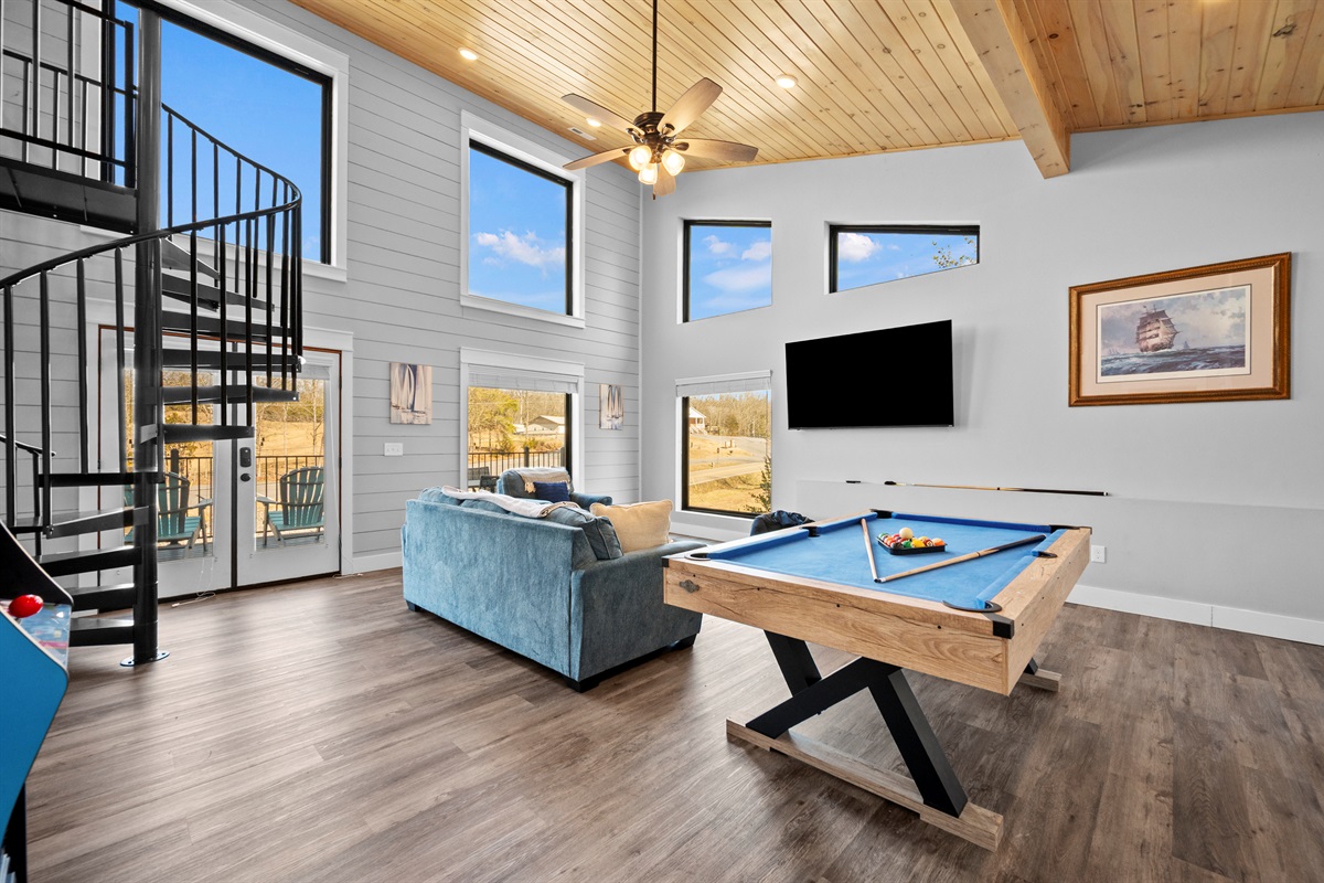 Game room with pool table, large TV, and comfortable seating. A favorite space for friendly competition and relaxing evenings.