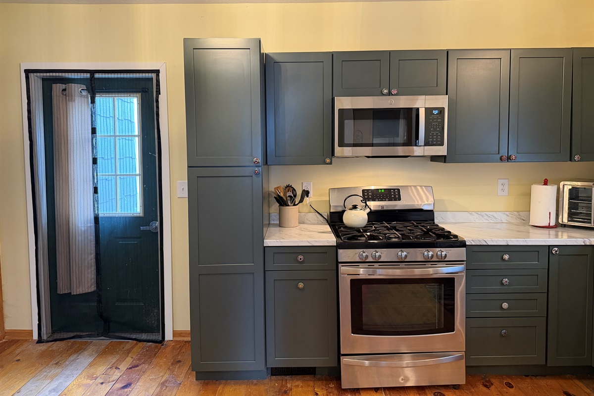 The kitchen leads out to a small patio.