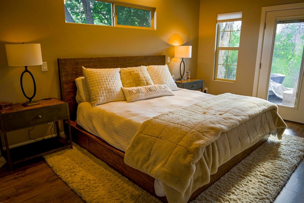 Master Bedroom with King Platform Bed with private outdoor patio space.