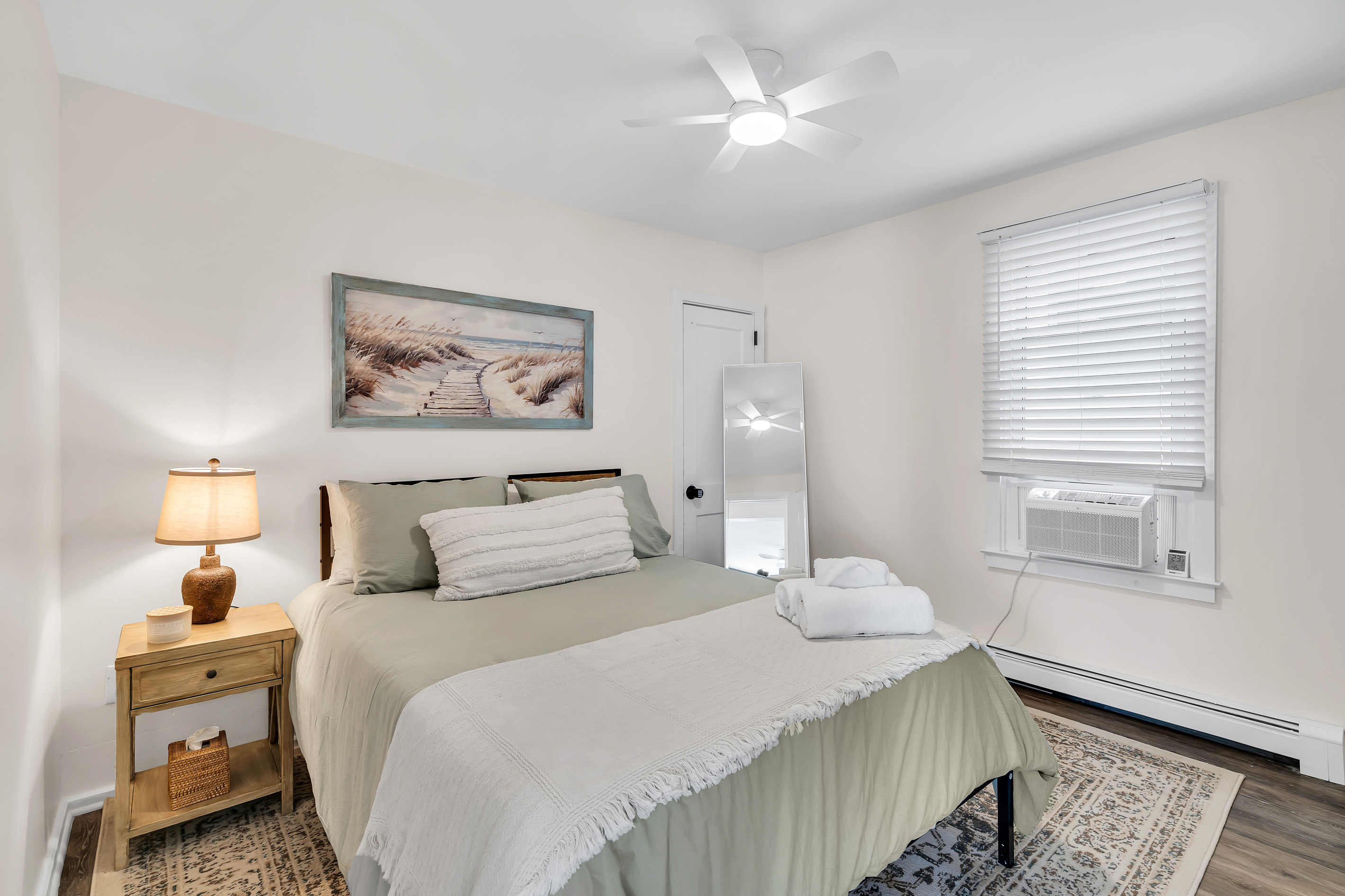 Stretch out in a restful second room with soft bedding and a bedside lamp. Pull the AC on, dim the light, and drift off after a full day by the water.