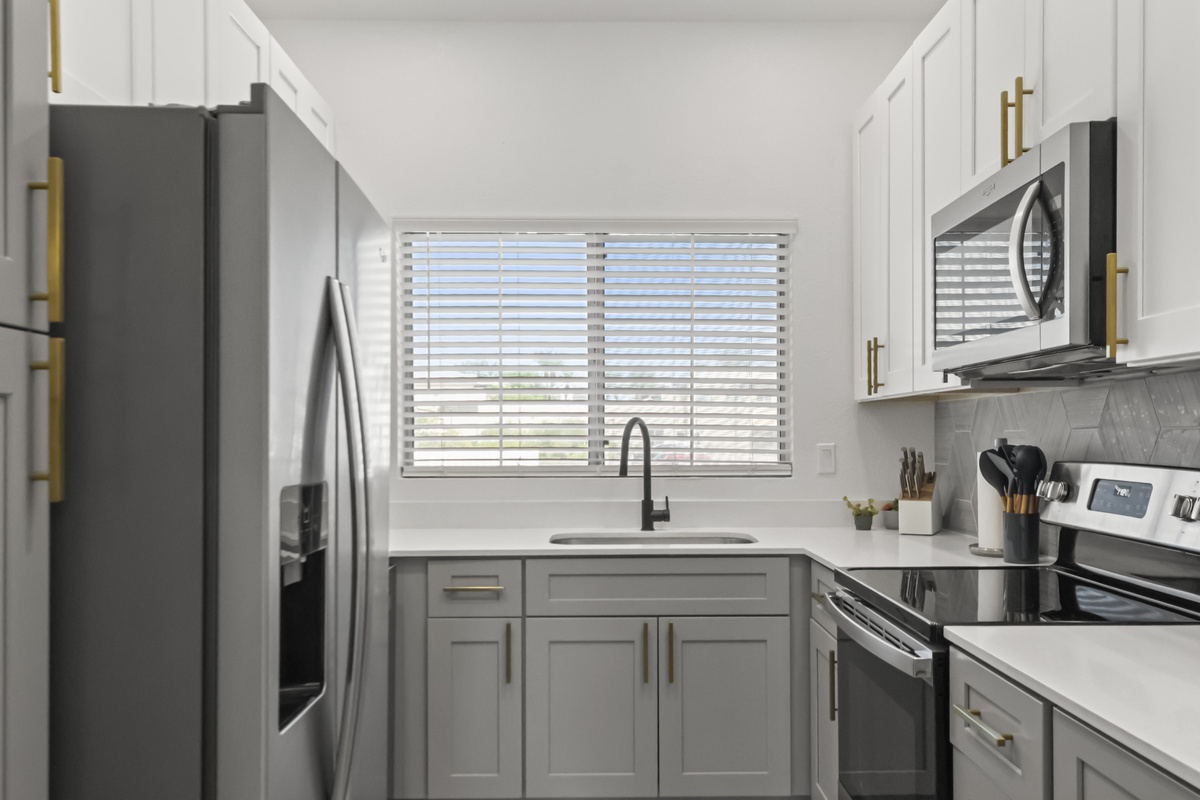 Fully equipped kitchen featuring stainless steel appliances, modern cabinetry, generous counter space, and everything you need for a convenient stay.