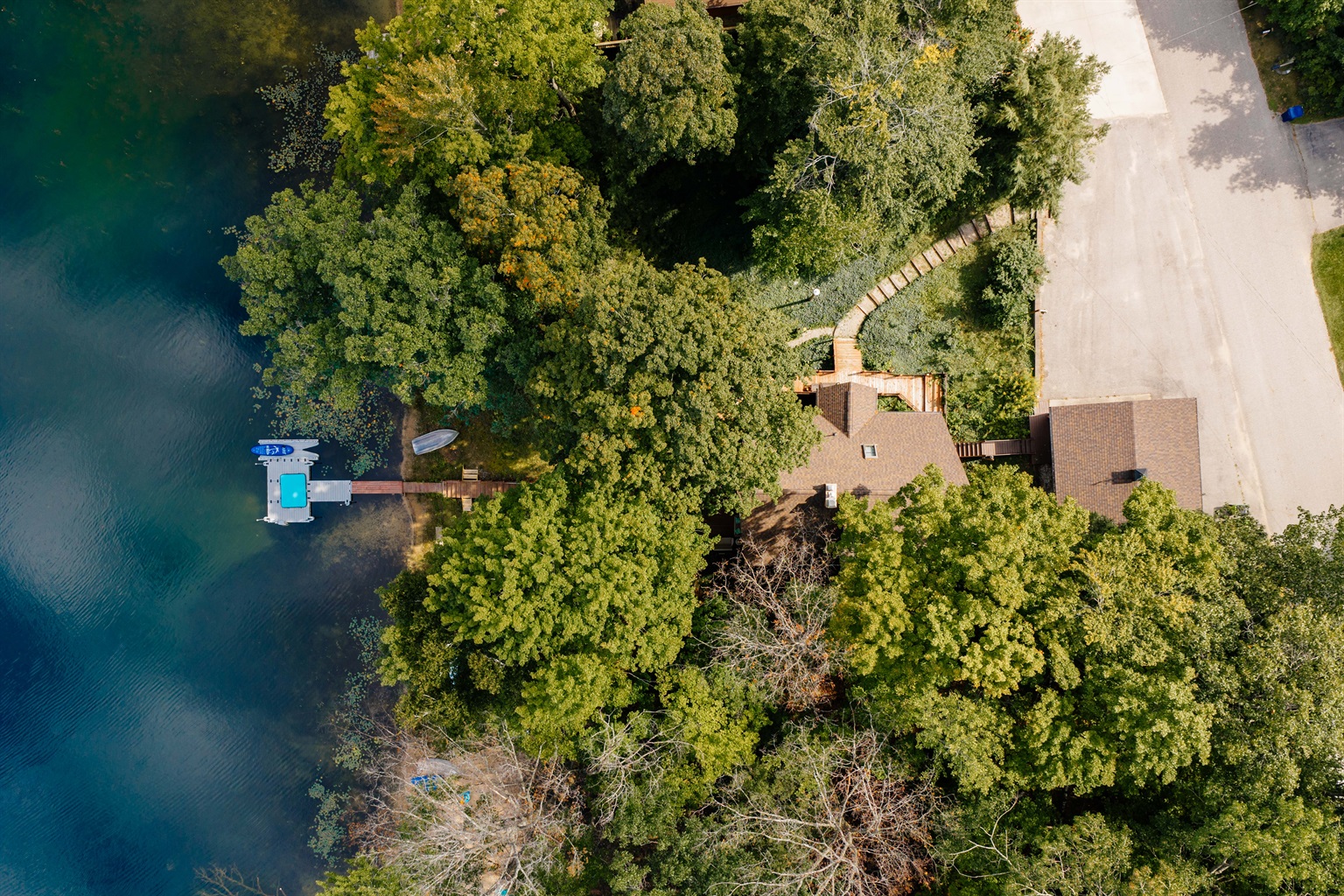 Aerial view of Loon’s Lakehouse tucked among the trees on Lake Ann