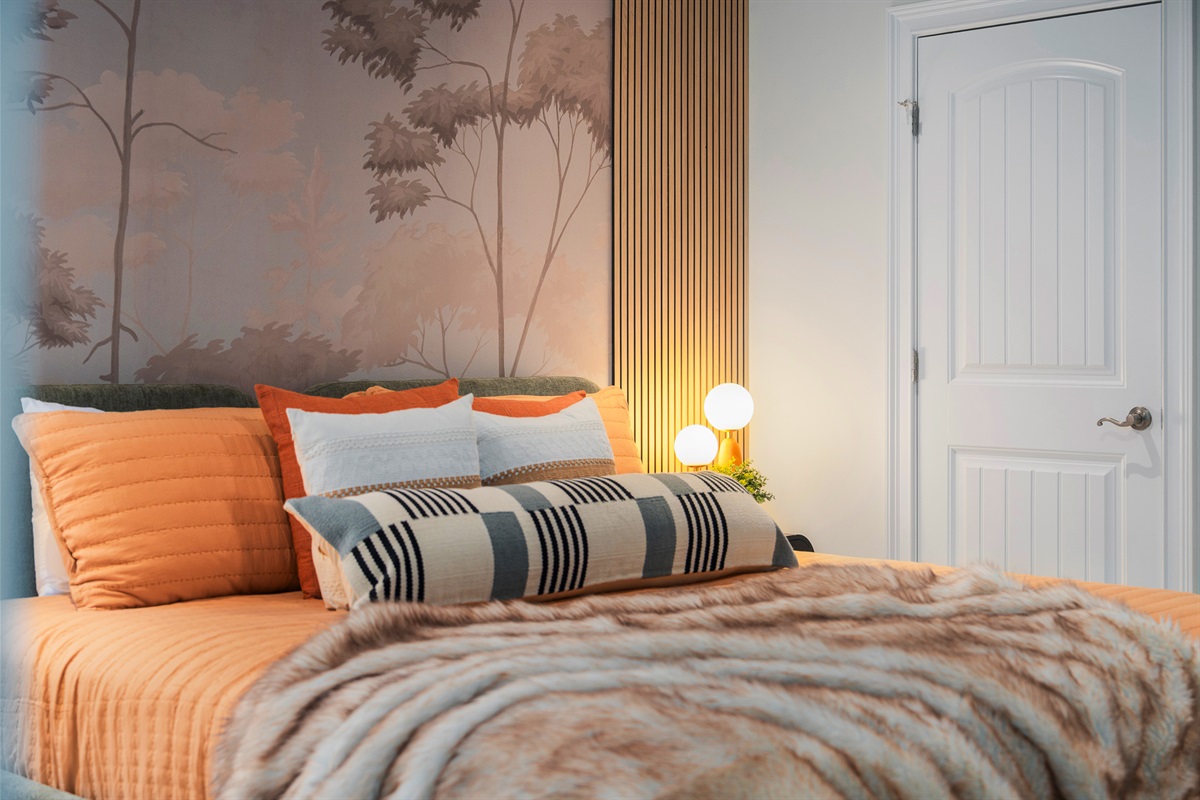 Bedroom with warm tones and layered design - thoughtfully styled for a comfortable stay
