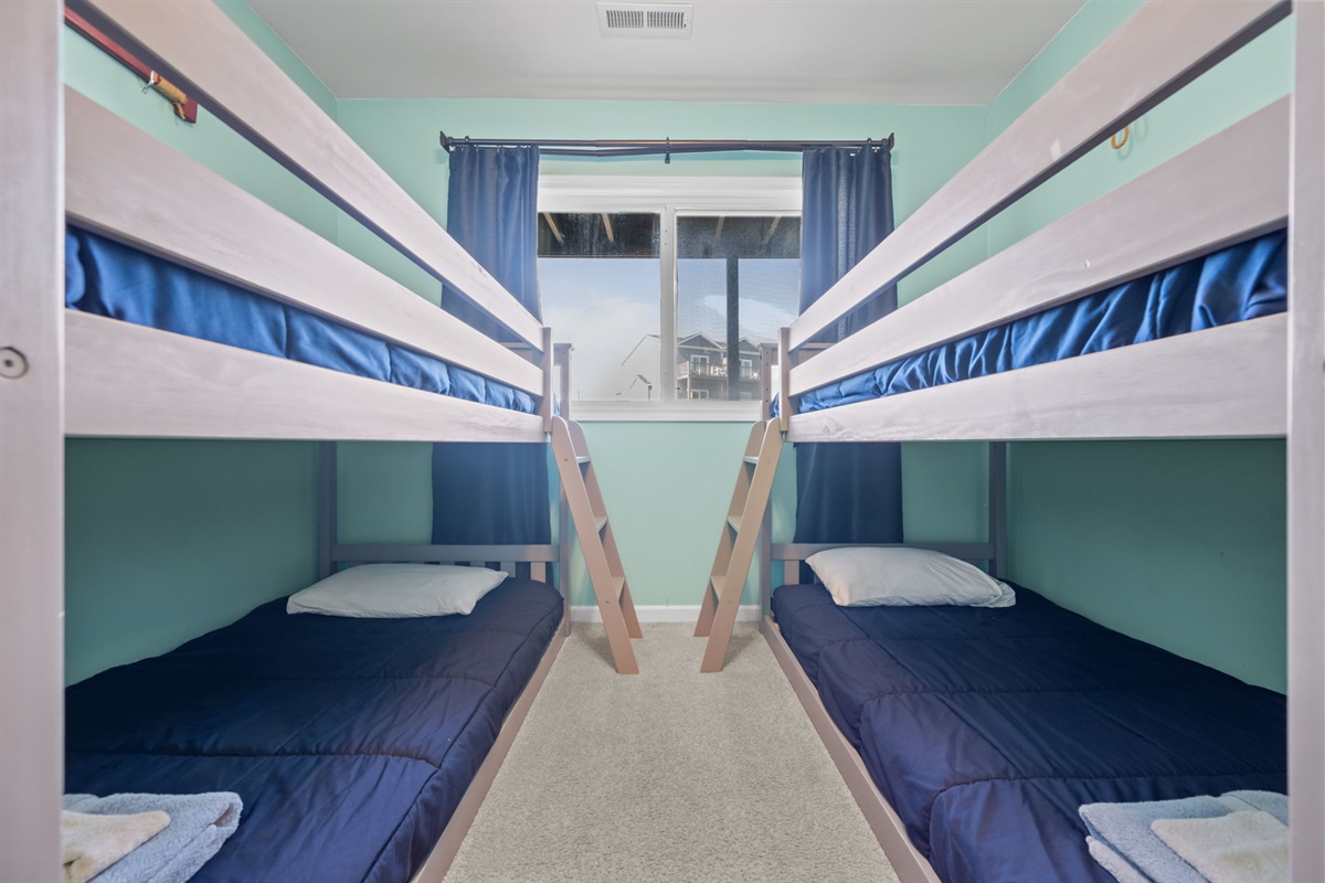 Built for sleepovers and family trips, this bunk room comfortably sleeps four with bright coastal colors and natural light