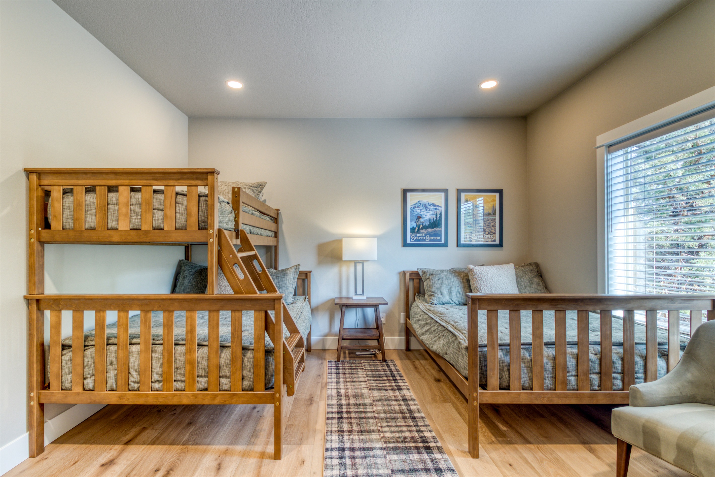 Our warm bunk room features two full beds and an upper twin with cozy bedding.