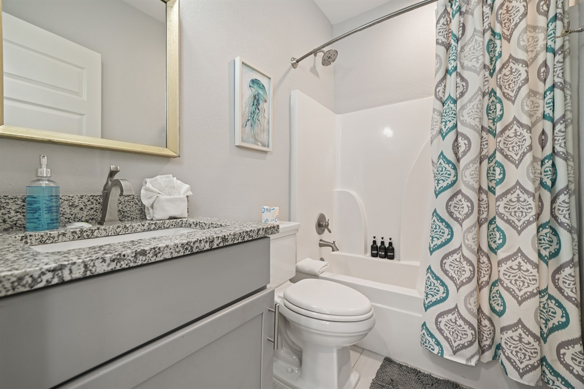 King Suite ensuite bathroom featuring granite vanity and modern fixtures.