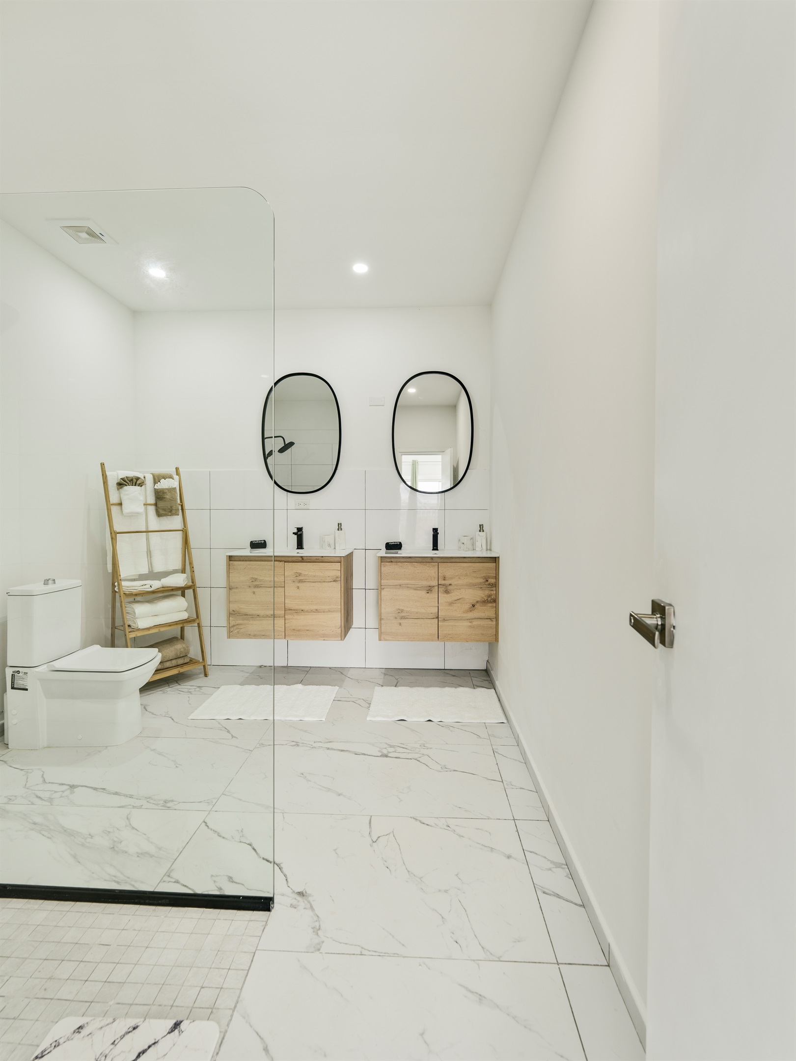 Full Bathroom Featuring Double Vanity, Ample Storage & Modern Toilet