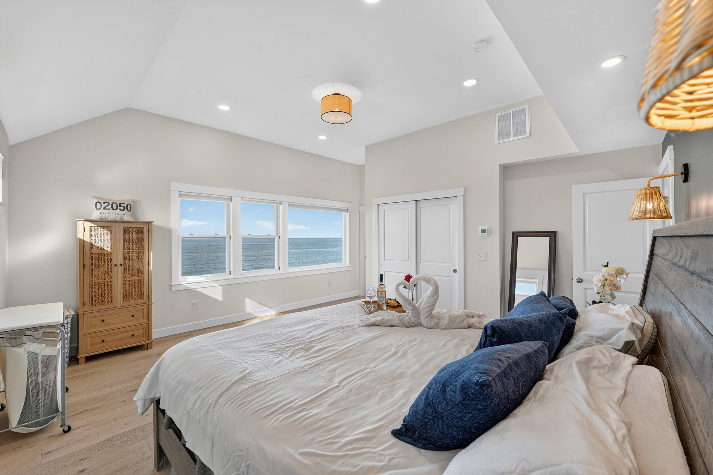 Wake up refreshed in this bright and spacious primary bedroom featuring a plush king bed, vaulted ceilings, and plenty of natural light.
