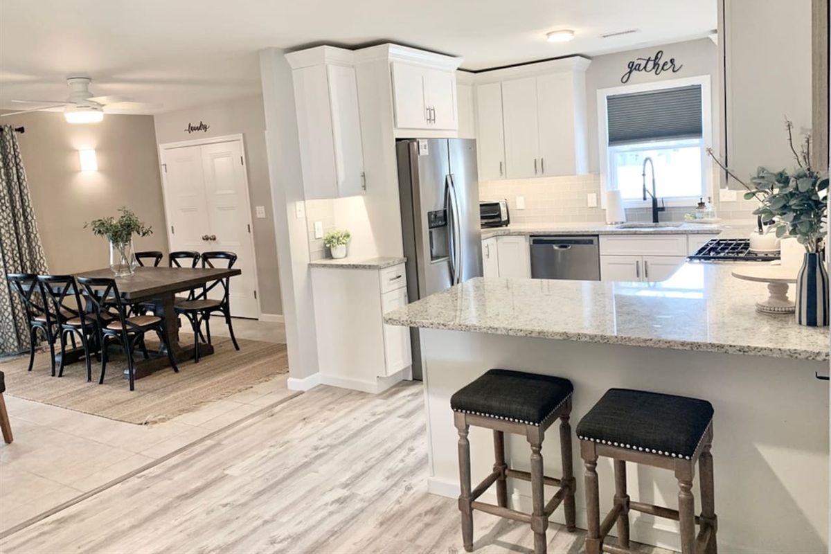 Our modern kitchen flows seamlessly into the dining area, featuring granite counters, stainless appliances, and a breakfast bar. The farmhouse dining table seats six, making it the perfect hub for family meals and conversation.