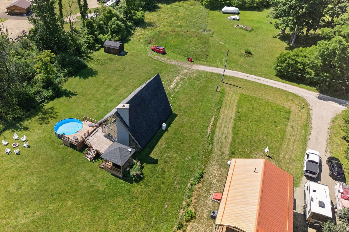 Aerial view showing the home and pool