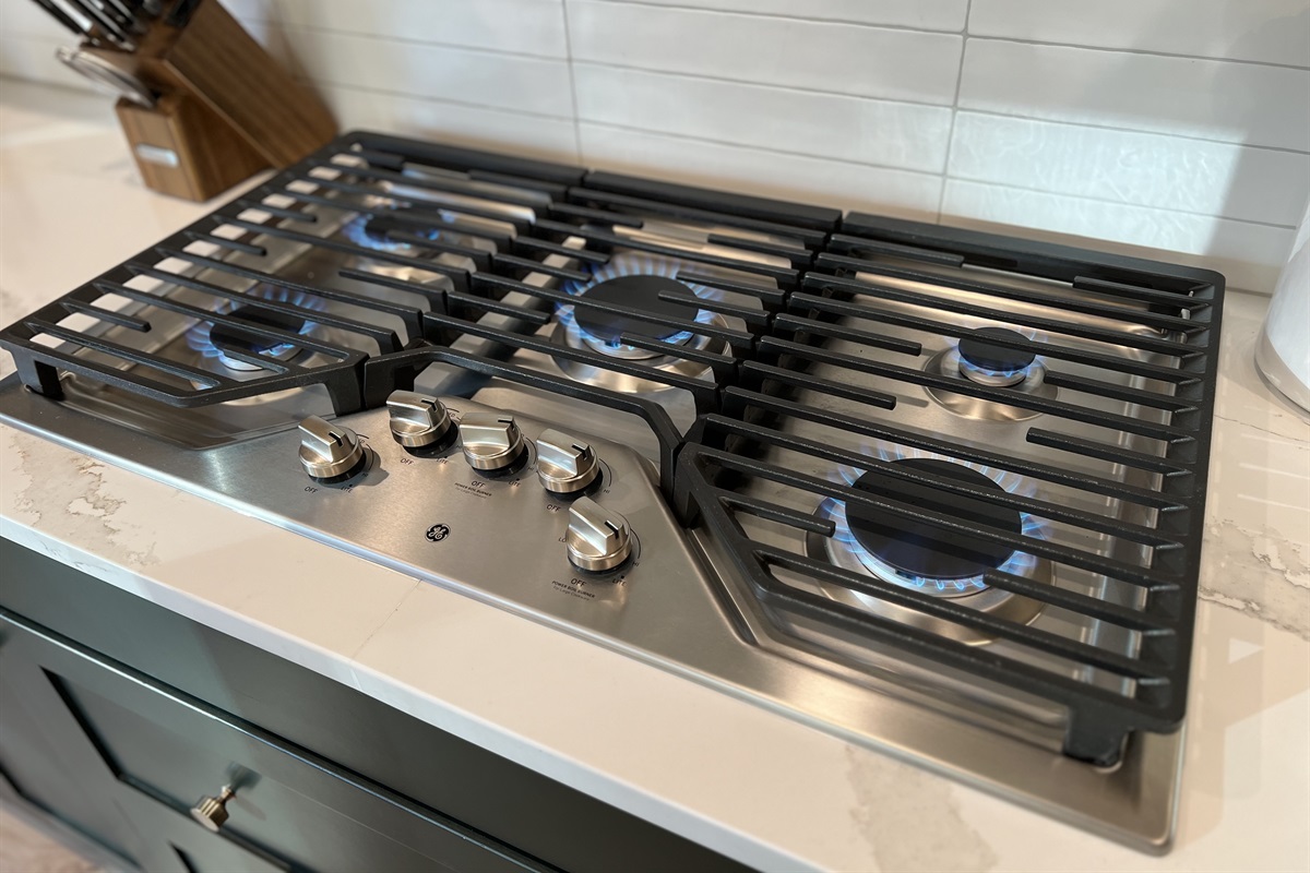 Space to cook for a group on the 5-burner gas cooktop. 