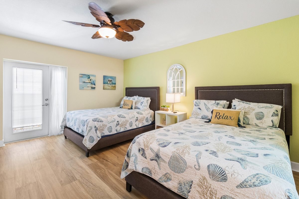 Bedroom 2, ensuite bath, with a door that leads to the front balcony, and the exterior hallway.
