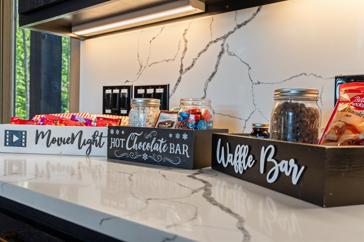 This fun snack station includes everything you need for the ultimate cozy stay: a Movie Night box full of treats, a Hot Chocolate Bar to warm your evenings, and a Waffle Bar perfect for sweet morning indulgence. A delightful touch!