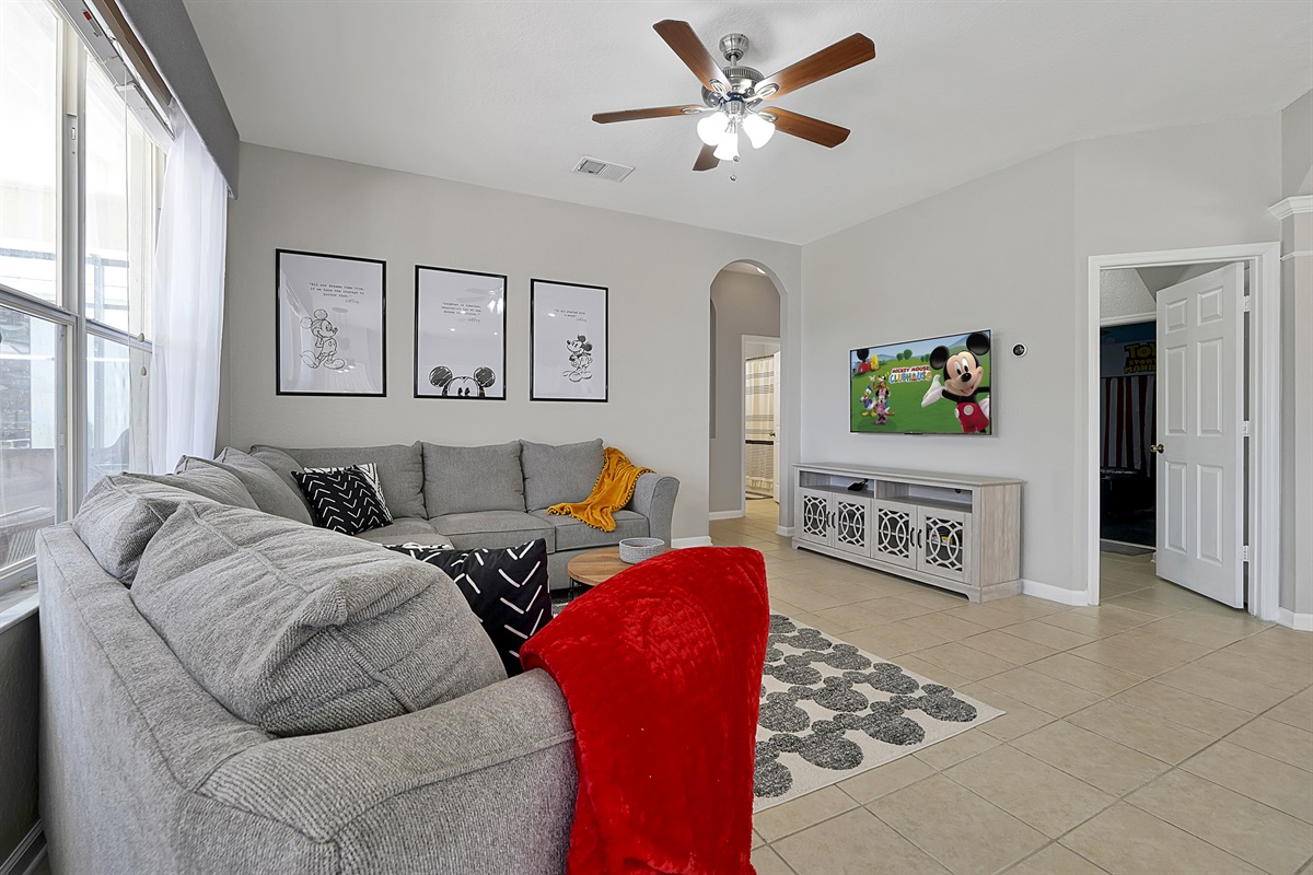 With an open concept design and classic Mickey decor, the family room is located just off the kitchen. The large and comfortable sectional is ready for you to enjoy your favorite movies and shows on the 55&rdquo; Roku TV.
