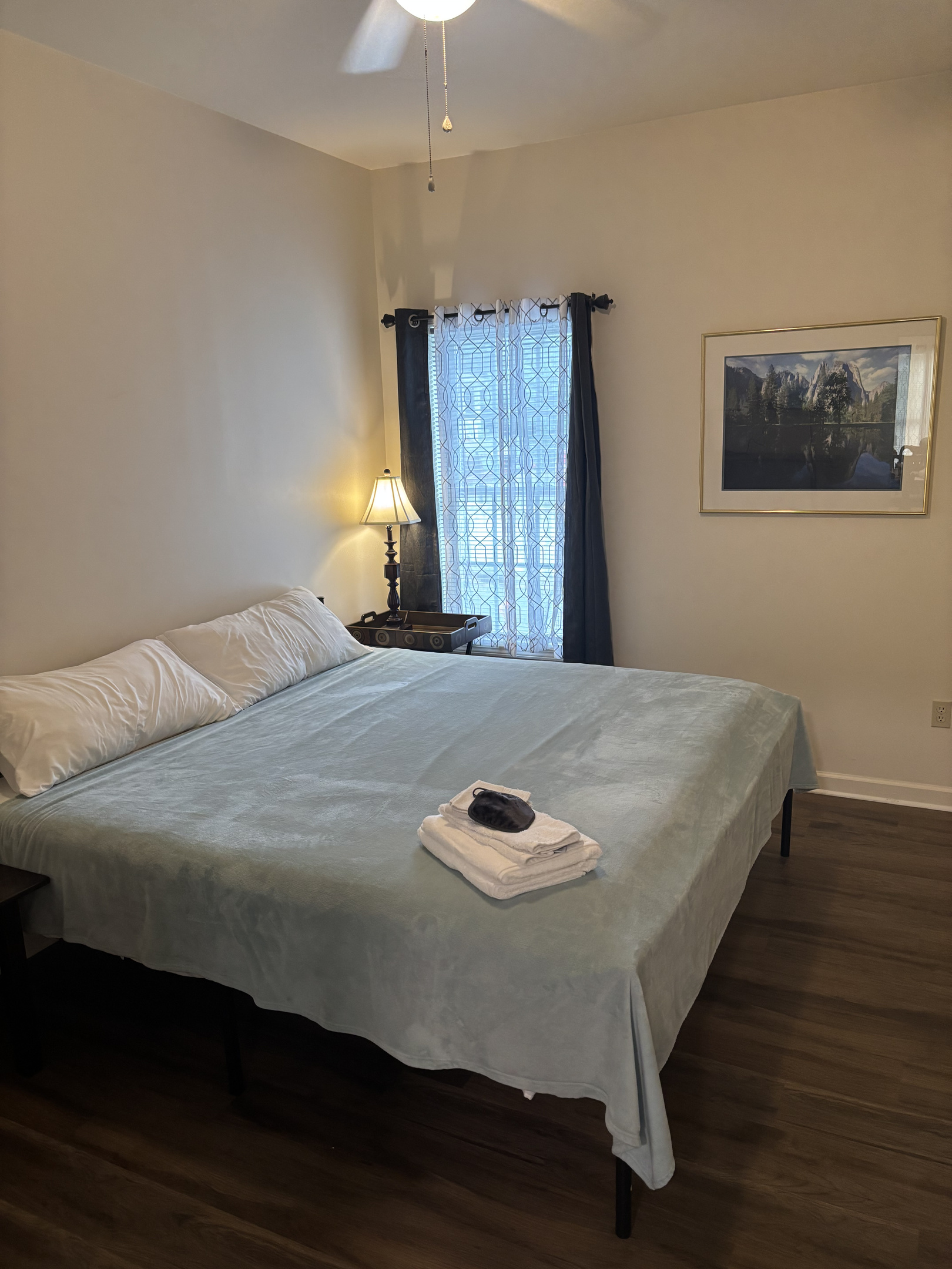 Spacious second king bedroom with blackout curtains, bedside lighting and a comfortable king bed.