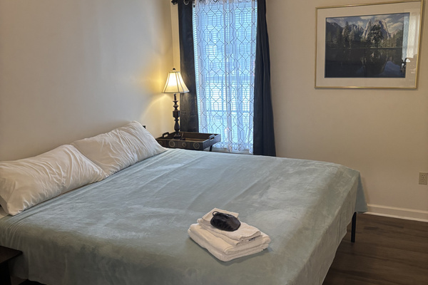 Spacious second king bedroom with blackout curtains, bedside lighting and a comfortable king bed.