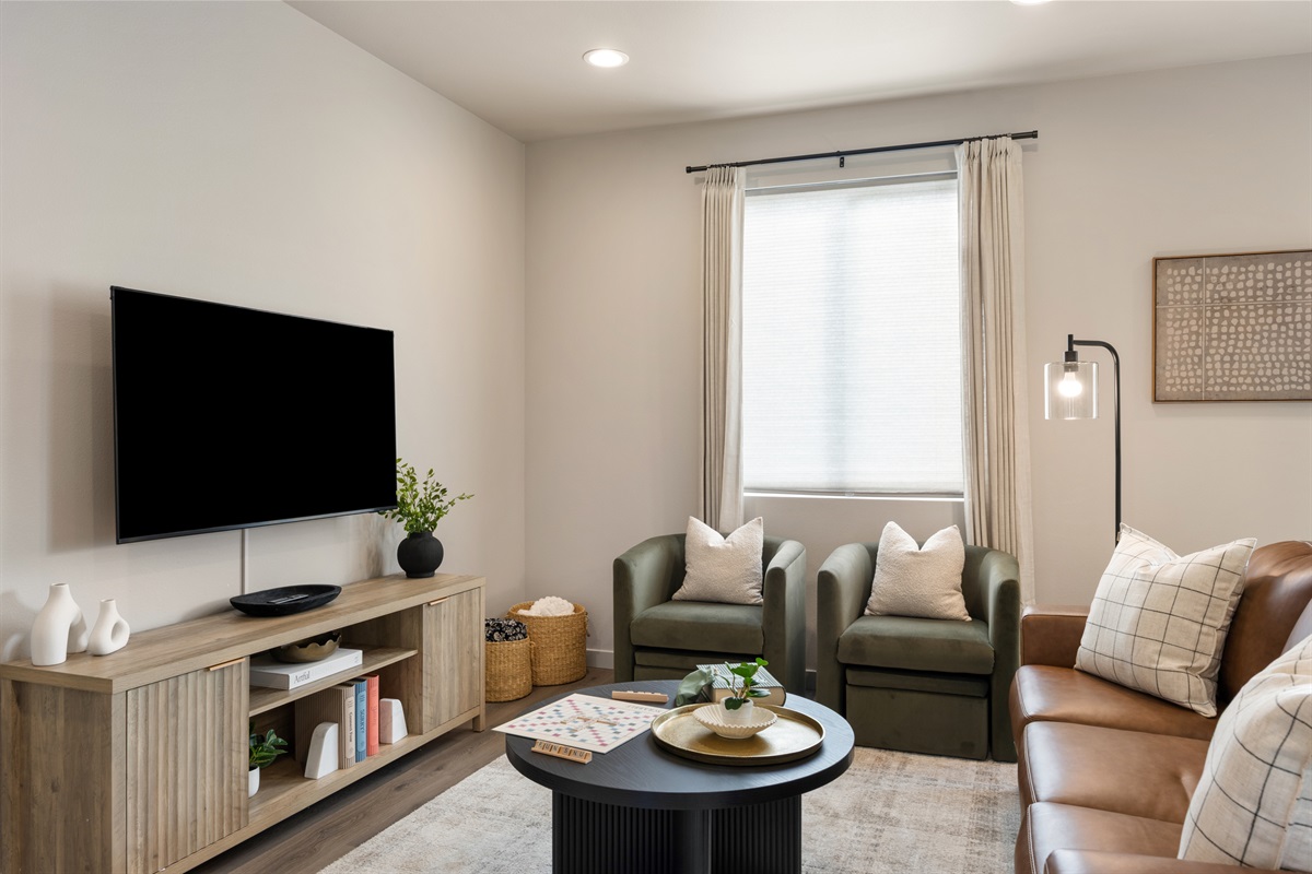 Cozy living room with sofa bed, board games, extra blankets